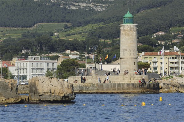 Lighthouse and people on the shore, Mediterranean coast, Cassis, Bouches-du-Rhône, Provence, France, Europe