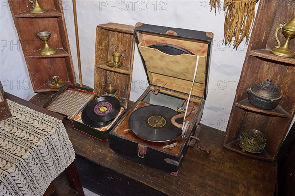 Close-up of an antique record player with records and decorative golden ornaments on a wooden shelf, Simantiris House, Chora, main town of Patmos, Patmos, Old Town, Dodecanese, Greek Islands, Greece, Europe