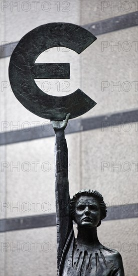 The bronze statue entitled Europe by May Claerhout holds up the euro symbol, Rue Wiertz, European Parliament, Brussels