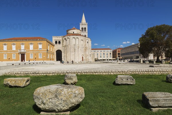 Architectural remnants on display at Roman forum ruins with the church of Saint Donatus and Bell Tower of Zadar Cathedral, Zadar, Croatia, Europe