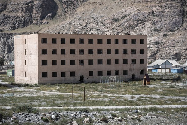 Abandoned, destroyed residential buildings, old Soviet apartment blocks in the ghost town, Engilchek, Tian Shan, Kyrgyzstan, Asia