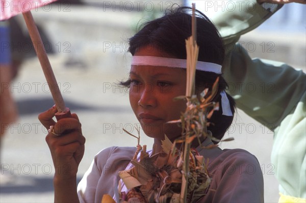 Ngaben (cremation ceremony), at the cremation site woman carry the remains of a family member from the cremation tower to the animal sarcophagus, Bali, Indonesia, Asia