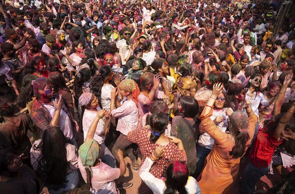 Revellers dancing in the beat of music as they celebrate Holi on a street, the Hindu spring festival of colours on March 25, 2024 in Guwahati, Assam, India. Holi, also known as the Festival of Colors or the Festival of Spring, is one of the most vibrant and joyous festivals in India