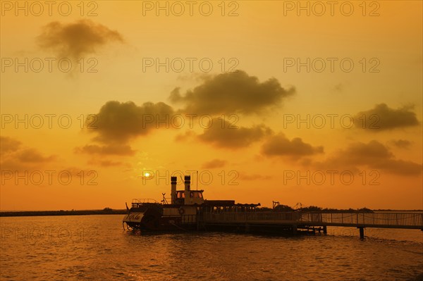 Paddle steamer Tiki III at the jetty at sunset, Les Saintes-Maries-de-la-Mer, Camargue, Provence, South of France