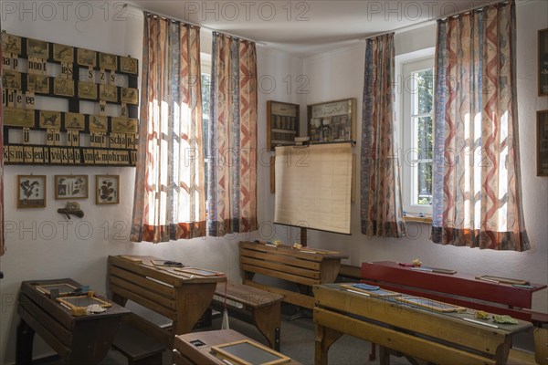 Retro classroom with wooden furniture, simple curtains and plenty of daylight through windows, school museum, Münsterland, North Rhine-Westphalia, Germany, Europe