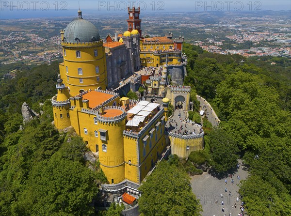 Historic castle in yellow on a hill with an impressive view and surrounded by forest, aerial view, Palácio Nacional da Pena, National Palace Pena, Sintra, Lisbon, World Heritage Site, UNESCO, Portugal, Europe