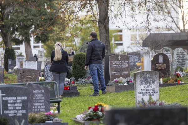 All Saints' Day at the Bergfriedhof cemetery in Stuttgart. Catholics commemorate their deceased relatives. Grave decorations and candles. Stuttgart, Baden-Württemberg, Germany, Europe