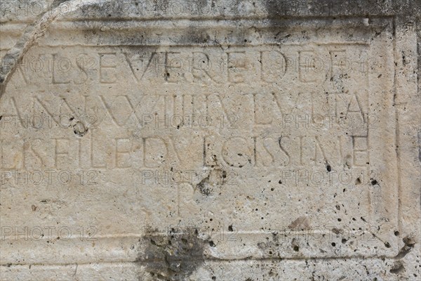 Close-up of carved letters on old slab of limestone at ancient 3rd century Roman ruins of Salona near Solin, Croatia, Europe