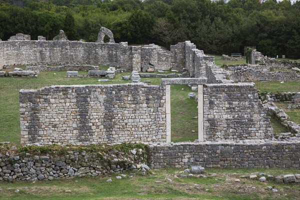 High angle view of old stone wall structure with entrance gate at ancient 3rd century Roman ruins of Salona near Solin in late summer, Croatia, Europe