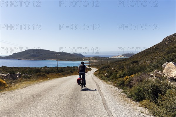 E-bike cycle tour, Bestager enjoys view of coastline, insider tip, Elafonisos, Deer Island, Laconia, Peloponnese, Ionian Islands, Ionian Sea, Greece, Europe