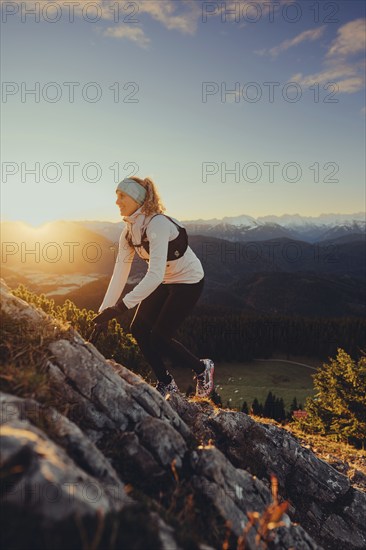 Trail running in autumn on the Jochberg on Lake Walchensee against the wonderful backdrop of the Alps, Bavaria, Germany, Europe