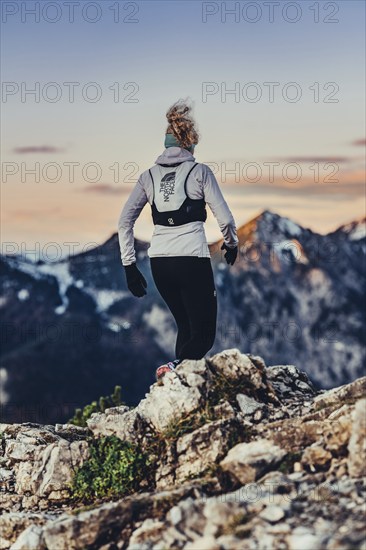 Trail running in autumn on the Jochberg on Lake Walchensee against the wonderful backdrop of the Alps, Bavaria, Germany, Europe