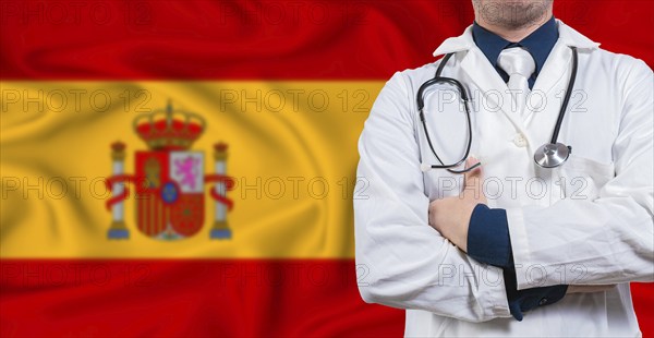 Male doctor with stethoscope on Spain flag. Doctor holding stethoscope on Spanish flag