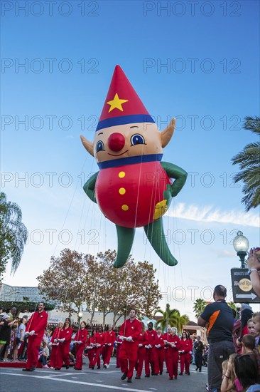 Elf helium balloon and its handlers in the Macy's Holiday Parade at Universal Studios, Orlando, Florida, USA, North America