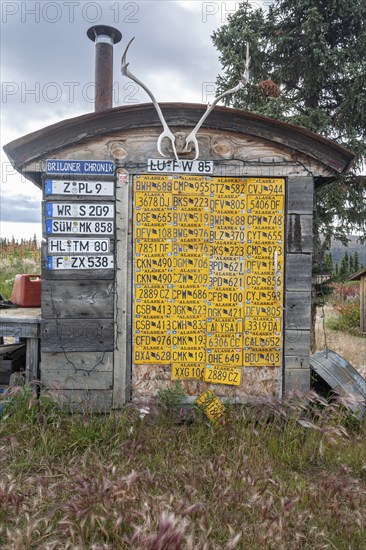 Funny wooden hut with car licence plates, collection, Top of the World Highway, Alaska, USA, North America