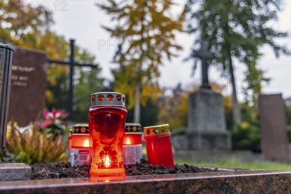 All Saints' Day at the Prague Cemetery in Stuttgart. Catholics commemorate their deceased relatives. Grave decorations and candles. Stuttgart, Baden-Württemberg, Germany, Europe