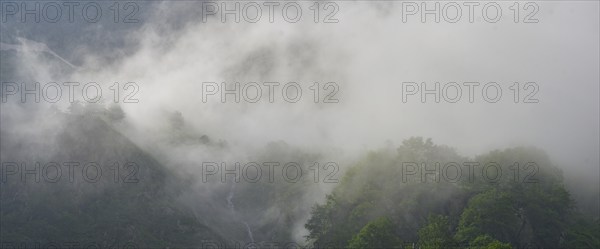 Clouds move over the mountains after a rain shower at Lago della Rovina, Entracque, province of Cuneo, Italy, Europe