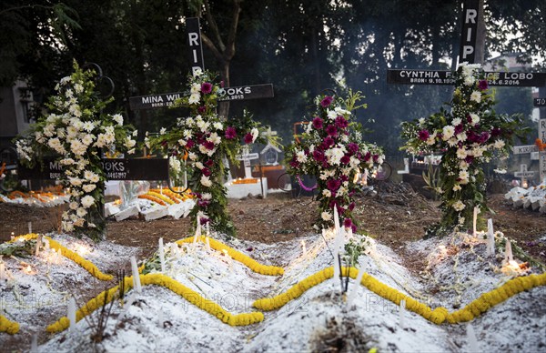 People from Christian community light candles and offer prayers on the grave of their relative during the All souls day observation, in Guwahati, India on 2 November 2024. All Souls' Day is a Christian holiday dedicated to honoring and praying for the souls of the departed