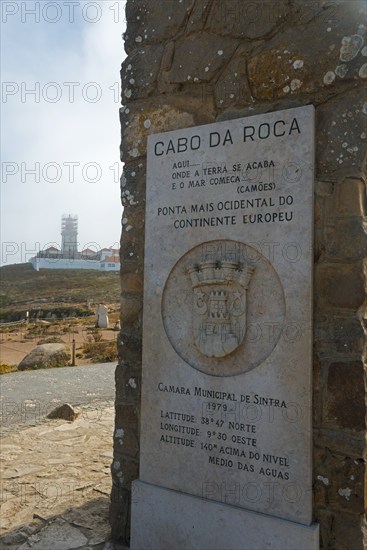 Stone plaque with information about Cabo da Roca, in the background a lighthouse, Cape Cabo da Roca, westernmost point of the European mainland, Atlantic coast, Sintra, Lisbon, Lisboa, Portugal, Europe