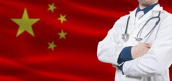 China Health Care concept. Male doctor on China flag. Doctor with crossed arms on China flag