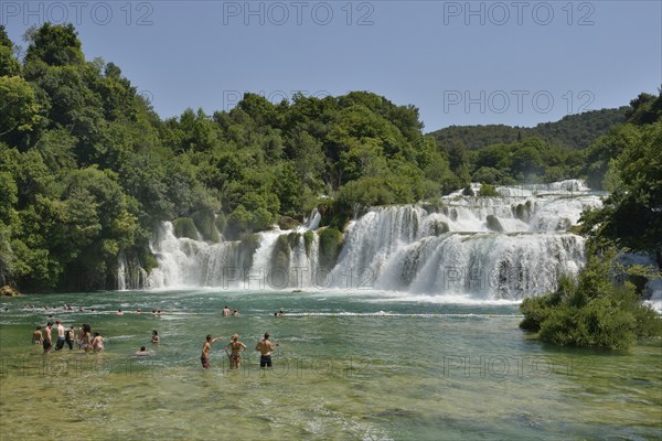 Tourists taking a bath at the Skradinski buk waterfalls, Krka National Park, Šibenik-Knin County, Dalmatia, Croatia, Europe