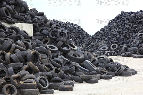 Old car tyres lie on stockpiles for recycling