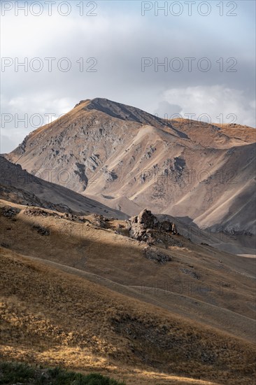 View of mountain landscape with mountain peak at Tyibel Pass, Song Kul Too mountain range, Naryn region, Kyrgyzstan, Asia