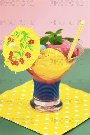 Sundae with homemade ice cream, yellow umbrella, ice cream cone and mint leaves, summer, Germany, Europe