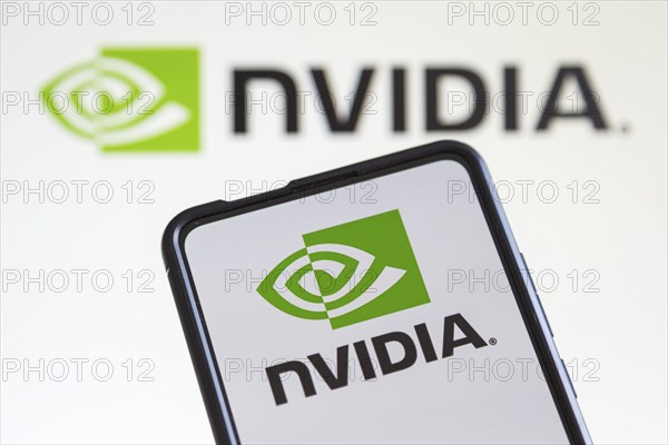 Nvidia logo of the developer of graphics processors on a mobile phone and computer screen