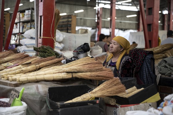 Vendor selling brooms, market stall at the Osh Bazaar, Bishkek, Kyrgyzstan, Asia