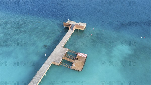 Aerial view bird's eye view of jetty of Maldives Island of Maldives, in foreground jetty for seaplane in background dock for boat Dhoni, Filaidhoo, Raa Atoll, Maldives, Asia