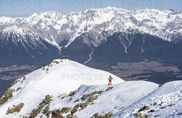 View of the Inn Valley, ski tourers at the summit of the Pirchkogel, mountains in winter, Sellraintal, Kühtai, Tyrol, Austria, Europe