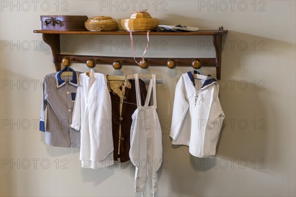 Old wardrobe with textiles and antique clothing