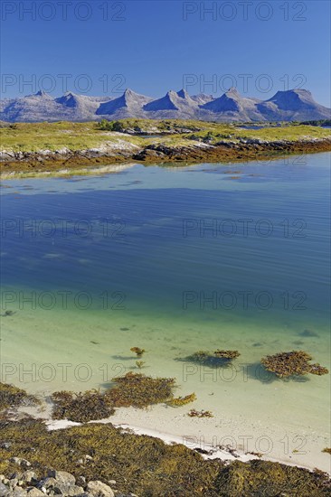 Crystal clear water of a shallow bay, seven mountain peaks, Seven Sisters, De syv søstre, Alstahaug, Nordland, Rv 17, Kystriksveien, Norway, Europe