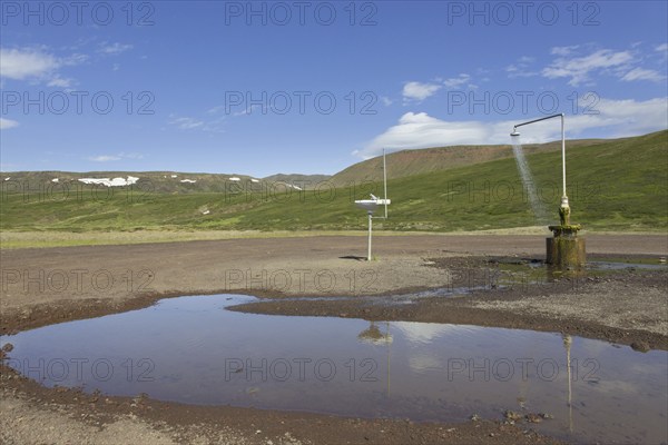 Shower and sink with hot water at Krafla, volcanic caldera in the Myvatn Geothermal Area in summer, North Iceland