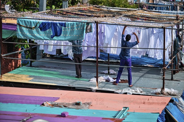 MUMBAI, INDIA, OCTOBER 31, 2019: Dhobi Ghat (Mahalaxmi Dhobi Ghat) is open air laundromat lavoir in Mumbai, India with laundry drying on ropes. Now signature landmark tourist attractions of Mumbai