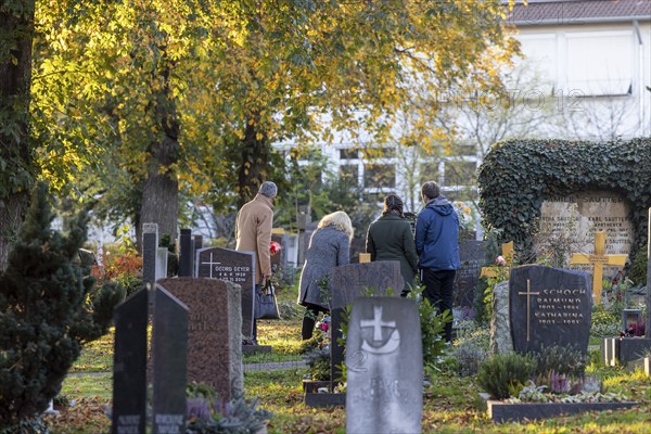 All Saints' Day at the Bergfriedhof cemetery in Stuttgart. Catholics commemorate their deceased relatives. Grave decorations and candles. Stuttgart, Baden-Württemberg, Germany, Europe