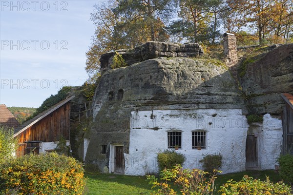 A rustic house integrated into a rock face, surrounded by autumn vegetation, rock dwelling, museum, Lhotka u Melníka, Melnik, Central Bohemia, Czech Republic, Europe