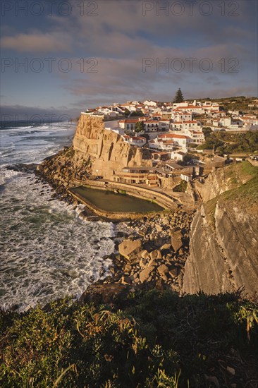 Scenic view of the seaside Azenhas do Mar fishing village on cliff on Atlantic ocean coast, Portugal on sunset