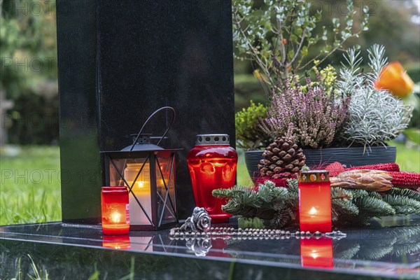 All Saints' Day at the Bergfriedhof cemetery in Stuttgart. Catholics commemorate their deceased relatives. Grave decorations and candles. Stuttgart, Baden-Württemberg, Germany, Europe