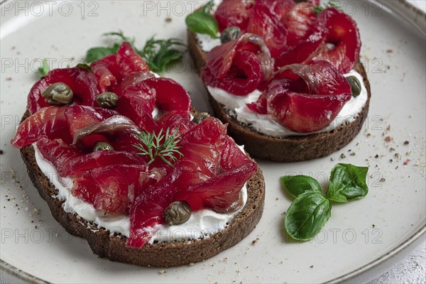 Sandwiches with gravlax salmon, cream cheese, capers, greens, breakfast, homemade