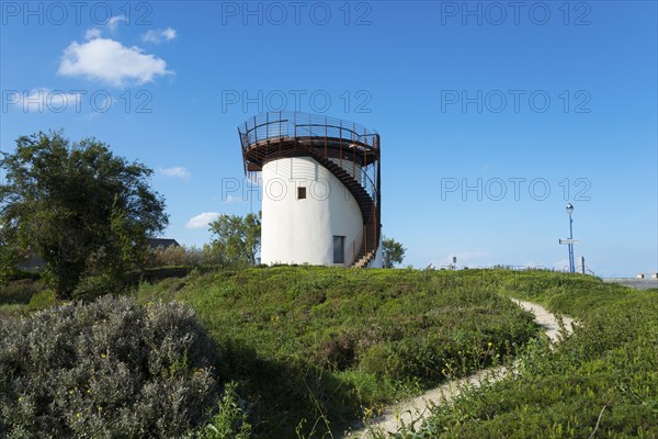 An old mill with spiral staircase, surrounded by nature and under a blue sky, old mill of La Croix, viewpoint over the bay of Mont-Saint-Michel, Belvedere des Ondes, Saint-Benoît-des-Ondes, Saint-Benoit-des-Ondes, Ille-et-Vilaine, Brittany, France, Europe