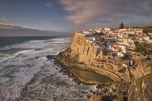 Scenic view of the seaside Azenhas do Mar fishing village on cliff on Atlantic ocean coast, Portugal on sunset