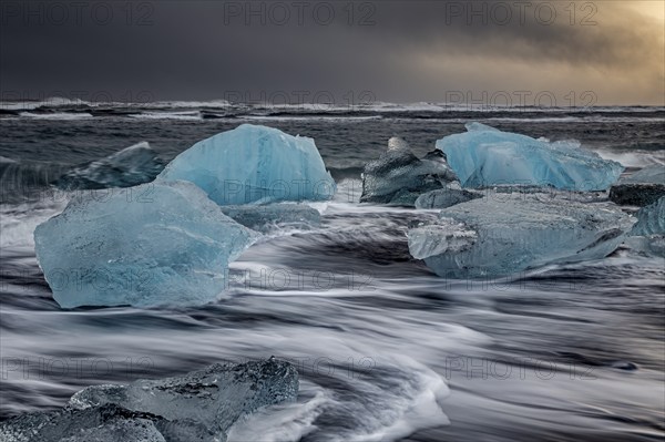 Ice floes in the sea during a storm and heavy spray, Breidamerkursandur, Jökulsarlon, south-east Iceland, Iceland, Europe