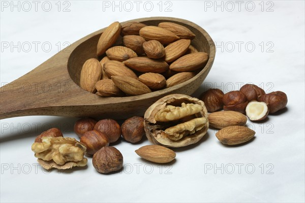 Wooden ladle with various nuts