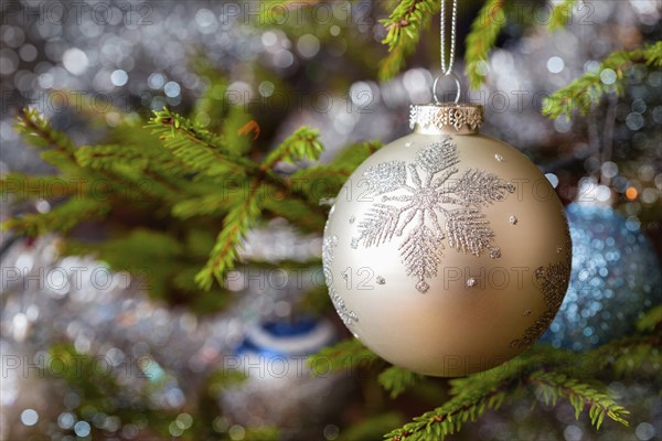 Christmas celebration holiday background, christmas-tree decoration bauble on decorated Christmas tree with defocused blurred lights bokeh and copyspalce