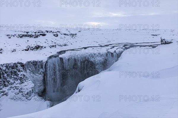 Dettifoss waterfall with icy and snow-covered rock face, snow-covered landscape, Northern Iceland Eyestra, Iceland, Europe