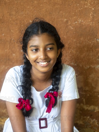 Sinhalese schoolgirl with white clothes, black braids and red ribbons, Sri Lanka, Asia