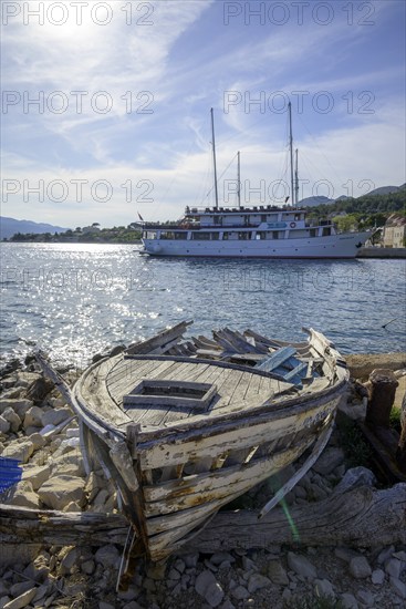 Old boat and behind it ship Meridijan, Kucište, Orebic, Pelješac Peninsula, Dubrovnik-Neretva County, Croatia, Europe