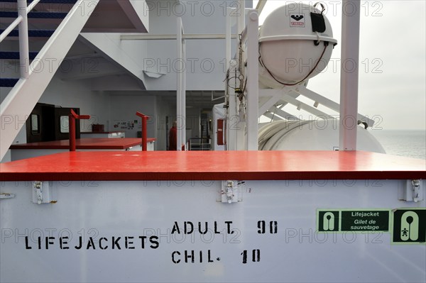 Box of life jackets and inflatable life rafts in hard-shell canisters on board a ferry boat